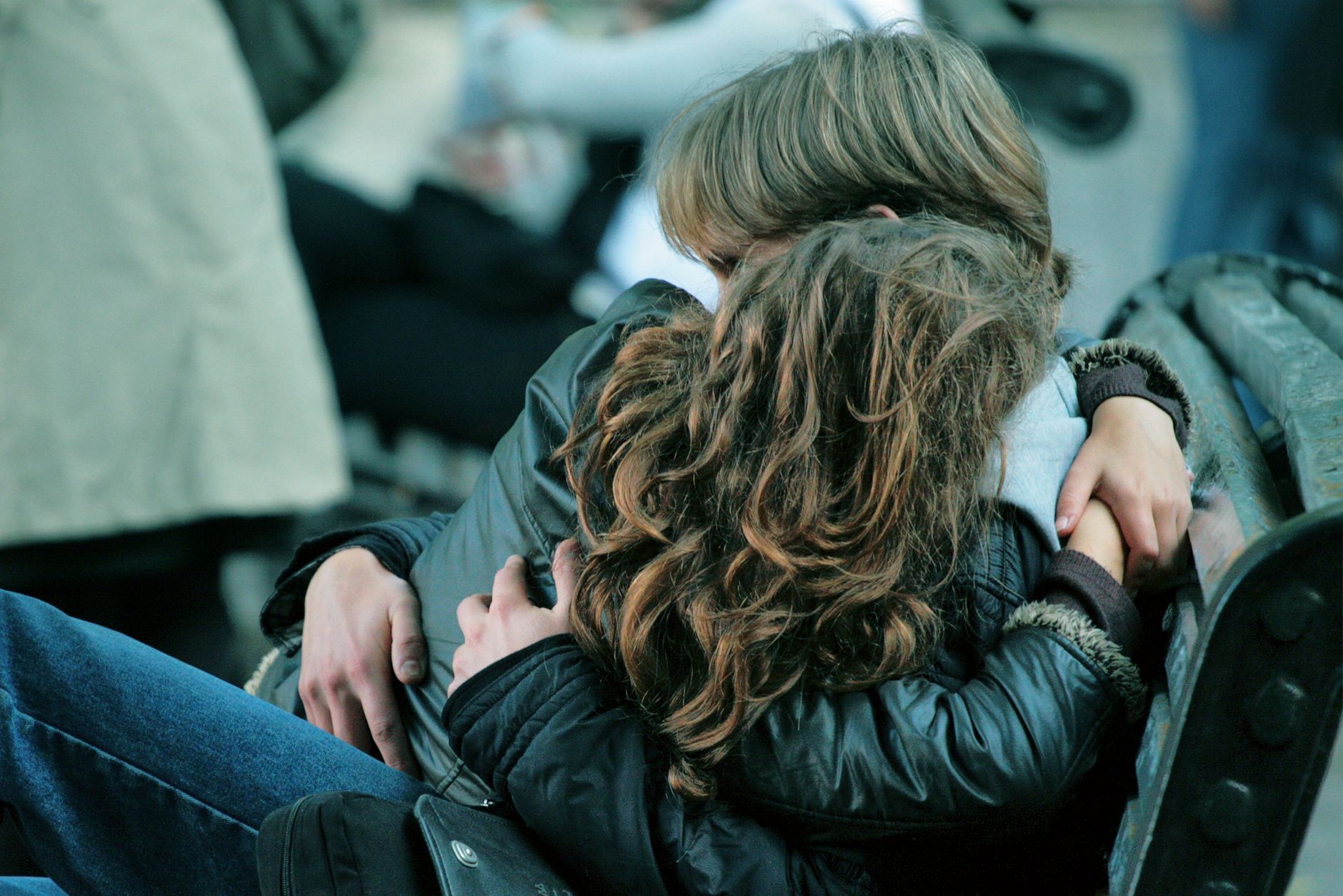 tender embrace on an outdoor park bench